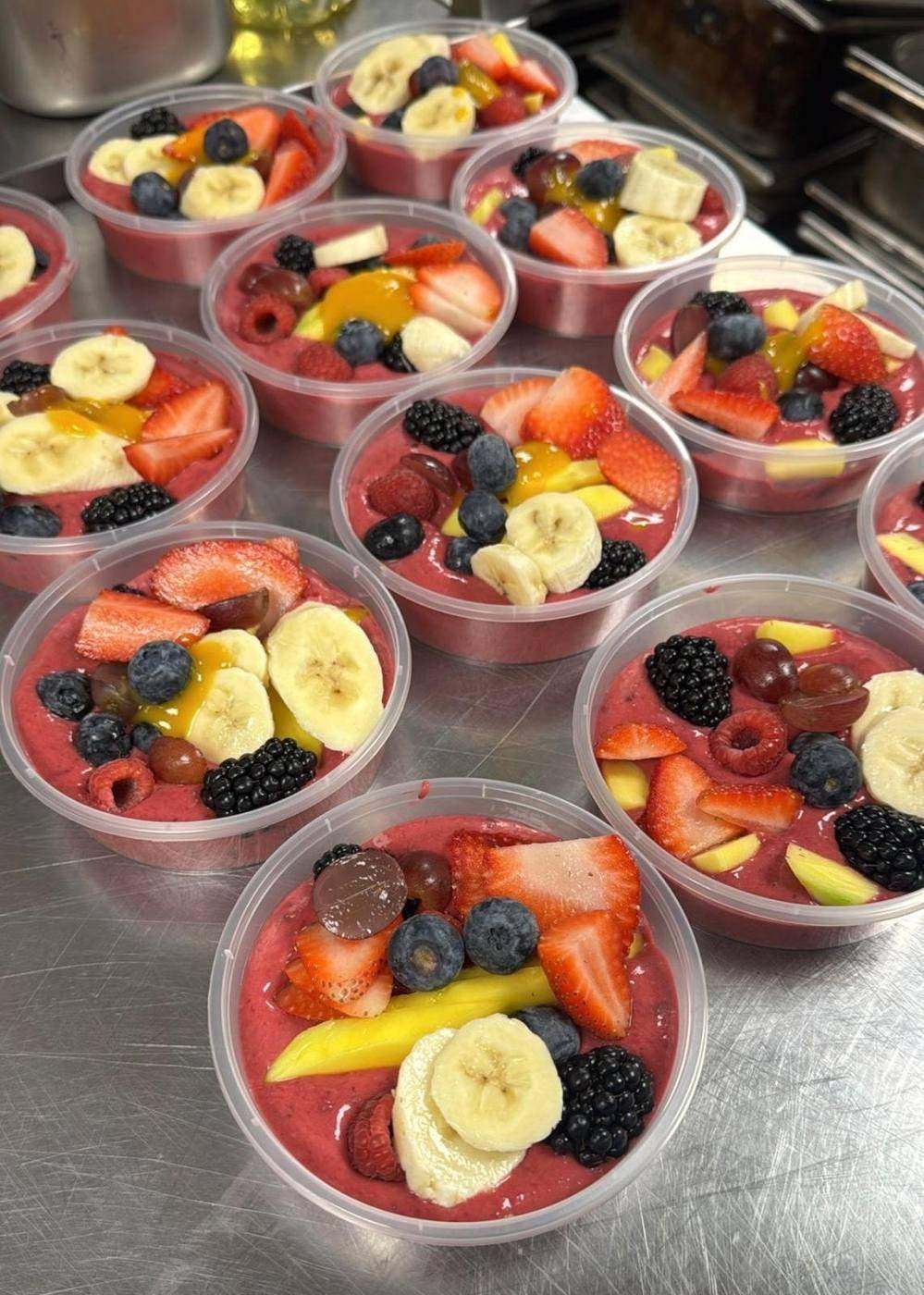 Individual fresh fruit pots with berries and banana