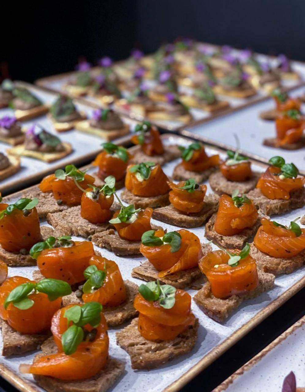 Trays of canapés topped with basil