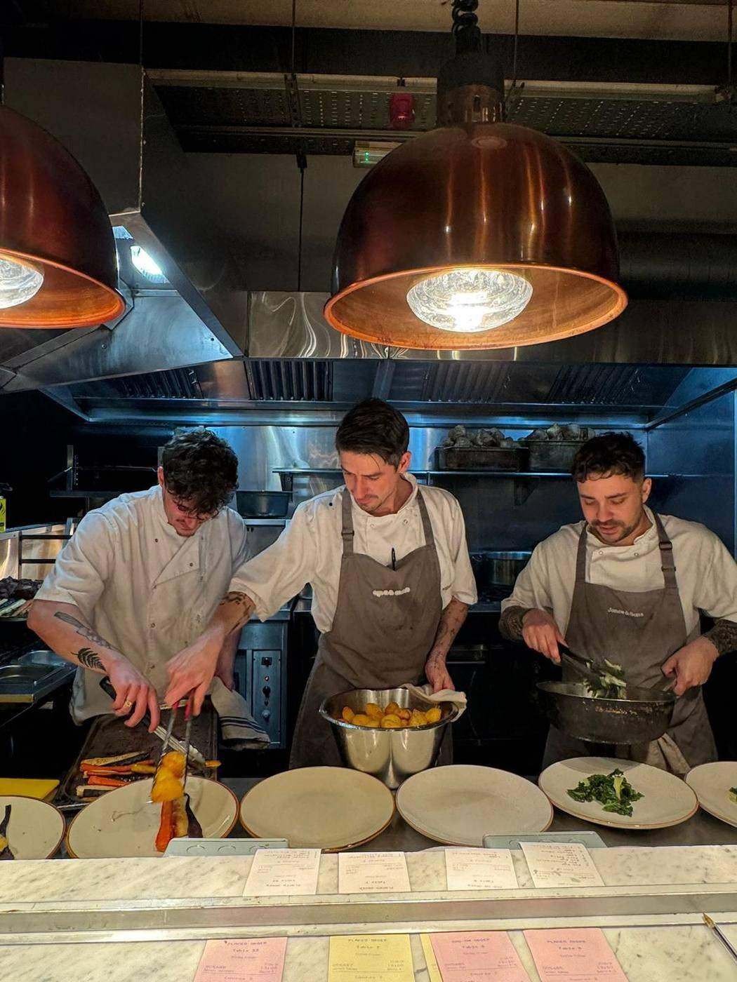 Three Jones & Sons chefs plating in the kitchen