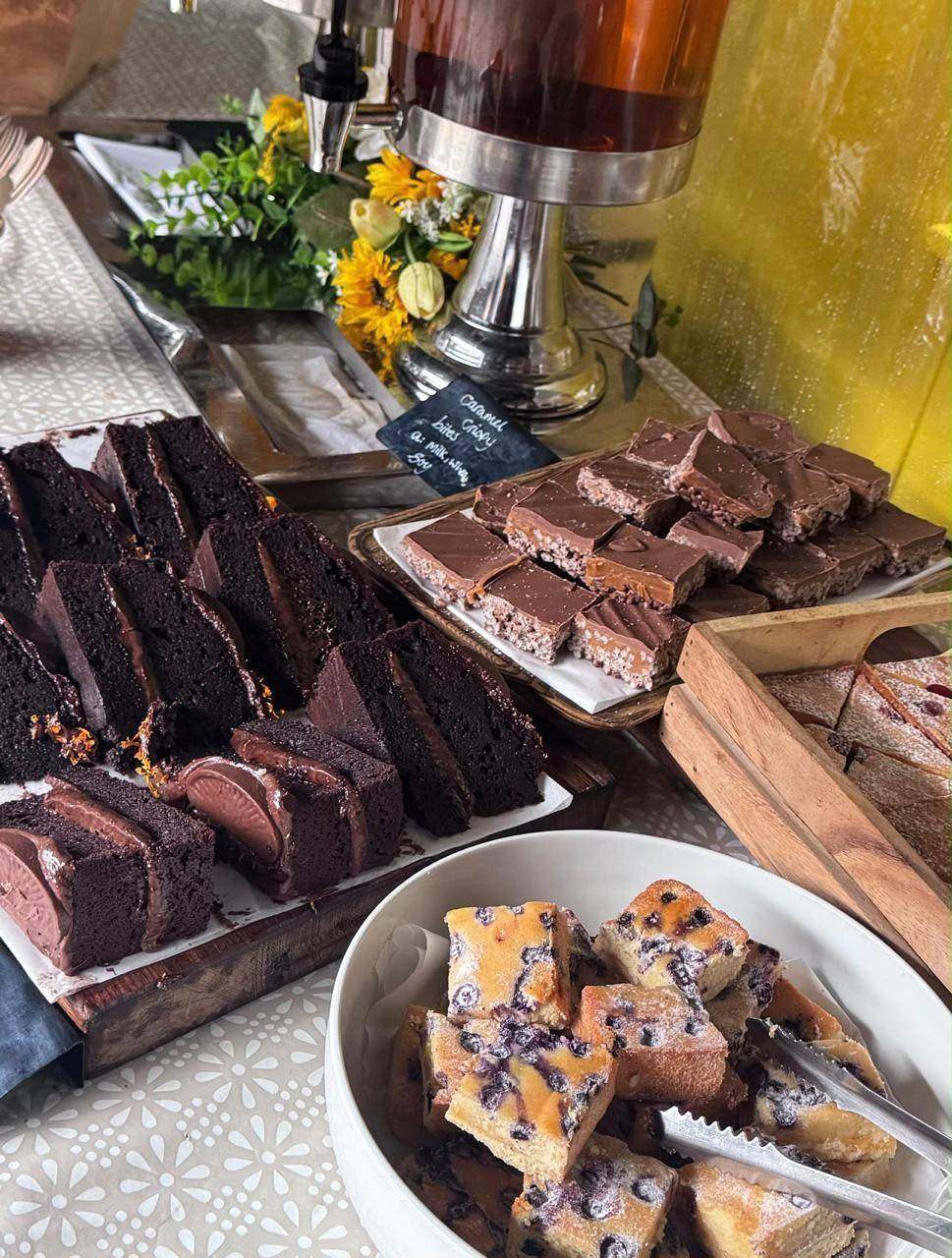 Chocolate cake, brownies and traybakes beside a hot drinks urn